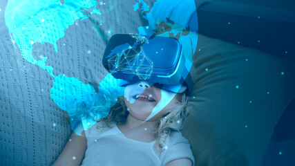 Little girl watching a movie through VR goggles