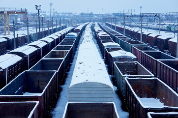 railway freight trains and wagons. rail cargos. rail transportation. railway freight station in gloomy winter day