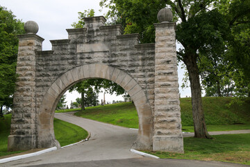 Fototapeta na wymiar old cemetery graveyard memorial park entrance with historic stone arch