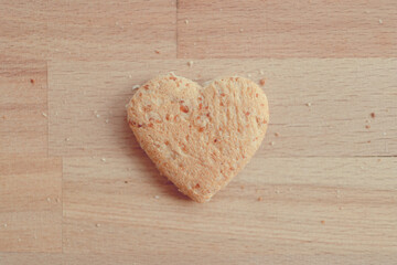 Grained bread cut off as heart shape. Concept of love and care in Valentine day.