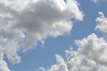 Obraz na płótnie Canvas White fluffy clouds on blue sky in summer