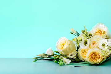 Mothers Day Card With White Roses On Mint Color Background With Copy Space. Bouquet of beautiful roses.