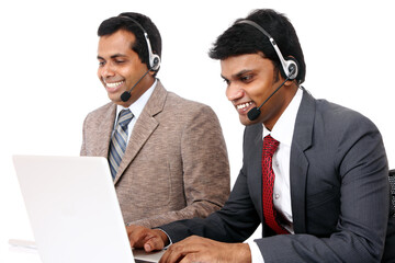 Indian young people working in call center isolated on white.
