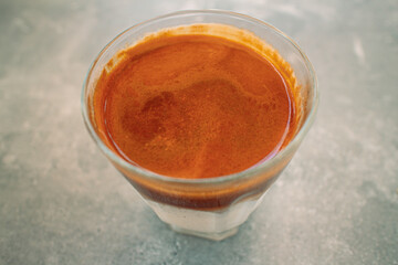 Close up of a cup of coffee on the table in the cafe.