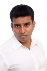 Angry Indian young businessman on white background.