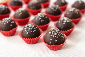 Chocolate coated almond London cookies in red paper cup