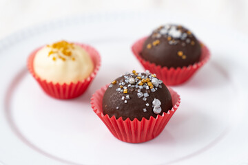 Dark and white chocolate coated almond London cookies in red paper cup