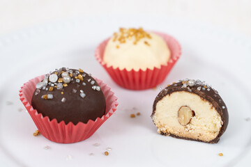Dark and white chocolate coated almond London cookies in red paper cup