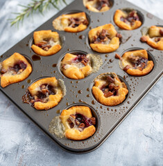 Brie bites with jam and nuts in crescent dough, mini appetizer dessert with cranberry or any jelly