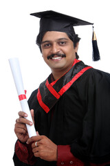 Cheerful Indian graduate on white background.
