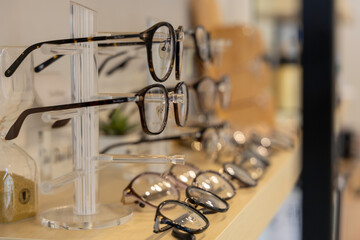 Close up glasses in optics store. Showcase spectacles in Optical shop.