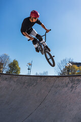 young man with brown skin in urban park.