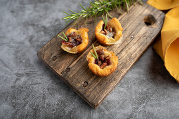 Brie bites with jam and nuts in crescent dough, mini appetizer dessert with cranberry or any jelly