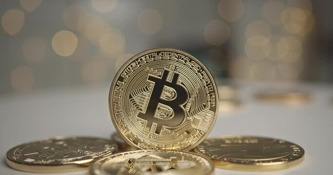 Digital cryptocurrency or golden bitcoin BTC on a table with bokeh background. A symbol of blockchain digital money for investting on a table.