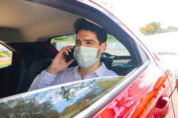 Businessman talking on phone in car.