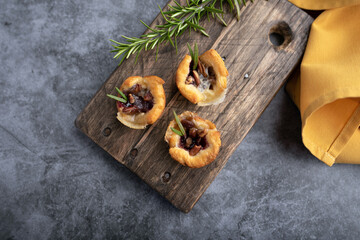 Brie bites with jam and nuts in crescent dough, mini appetizer dessert with cranberry or any jelly