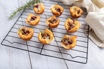 Brie bites with jam and nuts in crescent dough, mini appetizer dessert with cranberry or any jelly