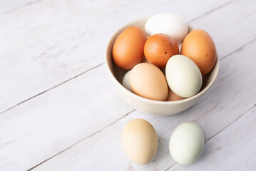 Fresh eggs from free range chickens on a small farm, beautiful colorful eggs from different breeds of chickens