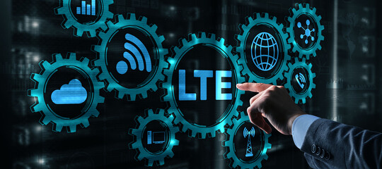 LTE concept on Server Room Background. Young business man presses with a finger LTE.