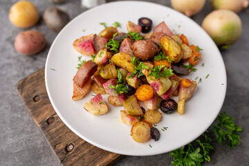 Roasted vegetables mix on a white plate ready to serve