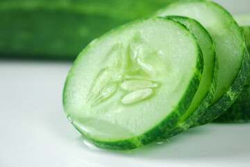 Fresh cucumber slices on white background.