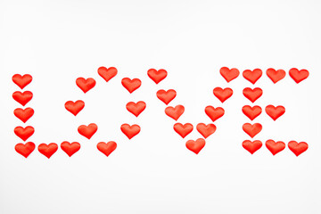 Lettering "love" of red textured hearts in the shape of a large red heart on a white background with space for text: background for Valentine's Day, mother's Day or international women's Day