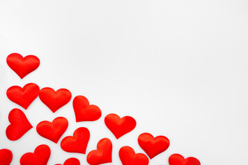 Many textured red hearts on top of each other on a white or gray background: place for text, St. Valentine's Day background, minimalism 