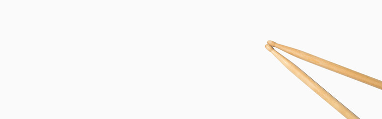 Drum sticks on a white background, top view. Banner, copy space.