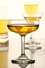 Glasses of alcohol drinks on whiite.