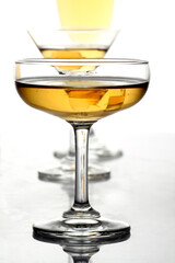 Glasses of alcohol drinks on whiite.