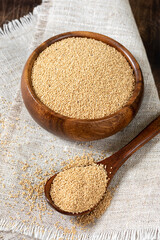 Amaranth. Amaranth seeds in a wooden bowl on a brown wooden kitchen table