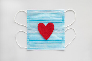 Masks with hearts on white background. Love and Valentines day during corona virus pandemic  concept.
