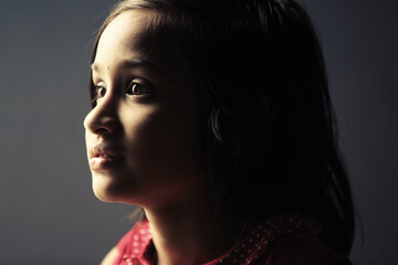 Fototapeta premium Low light portrait of Indian teen girl