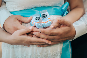 Hands on the belly of a pregnant woman