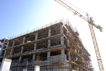 building under construction with tower crane