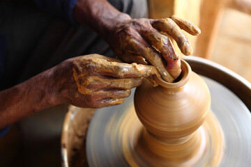 close up of hands of a potter