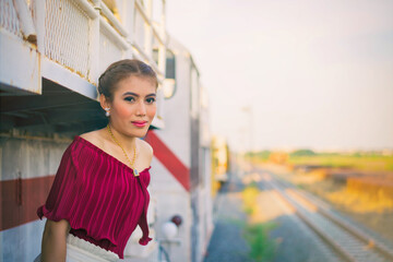Beautiful young woman posing on a train