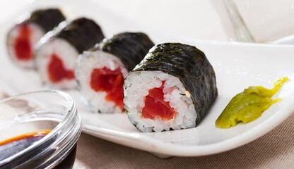 Maki sushi rolls with raw tuna inside served with wasabi