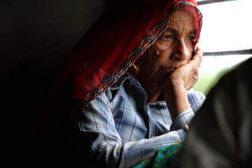 Old Indian women traveling in train alone.