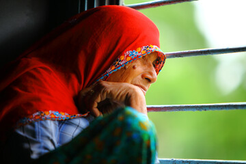 Old Indian women traveling in train alone.
