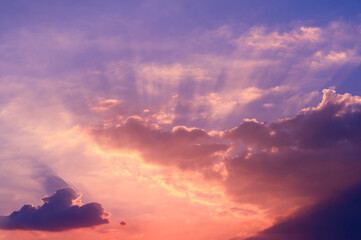 Fototapeta premium Sunbeams breaking through the clouds with blue and orange sky. Hope, prayer concept for background.