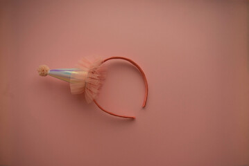 pink bezel with mother-of-pearl cap and pompon embellished with pink tulle