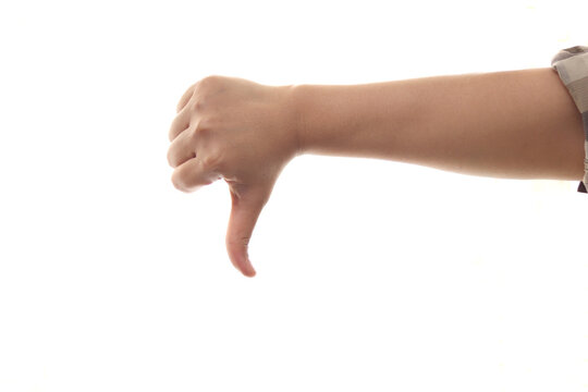 Hand of a person shows thumb down gesture, side view, isolated cut out on white