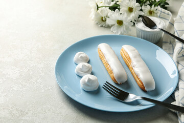 Concept of sweet meal with plate of tasty eclairs