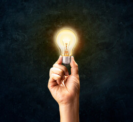 Business hand holding light bulb concept of new ideas, innovation, inspiration, creative thinking,...