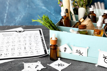 Alchemical symbols and ingredients for preparing potions on table