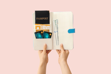 Female hands with travel organizer on color background