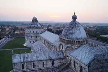 Fototapeta na wymiar View of the cathedral and baptistery of Pisa from the leaning tower at sunset, Tuscany, Italy