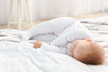 Obraz na płótnie Canvas Cute little baby sleeping on bed