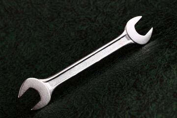 adjustable wrench on black